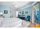 The airy bedroom has a balcony access, wood flooring, and serene light blue walls at 2801 S Ridgewood Ave # 1214, South Daytona, FL 32119