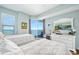 Inviting bedroom showcasing two twin beds, water views, and light blue walls and contemporary decor at 2801 S Ridgewood Ave # 1214, South Daytona, FL 32119