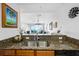 Kitchen close up of sink; view of living room and balcony at 2801 S Ridgewood Ave # 1214, South Daytona, FL 32119