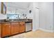 Kitchen sink with granite counters and wooden cabinetry; view of the living space at 2801 S Ridgewood Ave # 1214, South Daytona, FL 32119