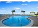 Outdoor pool with lounge chairs and lush landscaping, offering a perfect spot for relaxation and recreation at 2801 S Ridgewood Ave # 1214, South Daytona, FL 32119