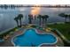 Relaxing poolside oasis offers lounge chairs, palm trees, and stunning water views at 2801 S Ridgewood Ave # 1214, South Daytona, FL 32119