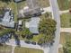An aerial view of a single-Gathering home with a gray roof, a fenced yard, and a large shade tree at 2821 Oak Lea Dr, South Daytona, FL 32119