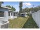 Spacious backyard featuring a storage shed, fenced yard, and lush greenery, perfect for outdoor enjoyment at 2821 Oak Lea Dr, South Daytona, FL 32119