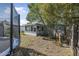 Lush backyard featuring a trampoline, sunroom extension, and mature trees, creating a private oasis at 2821 Oak Lea Dr, South Daytona, FL 32119