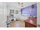 Well-lit Bedroom features tile floors, ample natural light, and playful toy kitchen for imaginative playtime at 2821 Oak Lea Dr, South Daytona, FL 32119