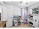 Bedroom with a toy kitchen, shelving, and a window with curtains at 2821 Oak Lea Dr, South Daytona, FL 32119