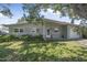 Charming single-story home with a well-maintained lawn and mature trees providing shade at 2821 Oak Lea Dr, South Daytona, FL 32119