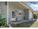 Charming front porch area with decorative plants and flowers adding to the curb appeal at 2821 Oak Lea Dr, South Daytona, FL 32119