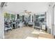 Bright sunroom with multiple windows, creating a workspace filled with natural light at 2821 Oak Lea Dr, South Daytona, FL 32119
