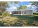 A view of the backyard with a screened porch and well-maintained lawn at 2841 Idleweise Dr, Deltona, FL 32738