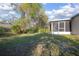 A view of the backyard with mature trees at 2841 Idleweise Dr, Deltona, FL 32738