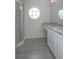 Bathroom with vanity, granite countertop, unique window, and glass standing shower at 2841 Idleweise Dr, Deltona, FL 32738