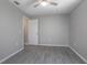 Neutral bedroom with hardwood floors, ceiling fan, and large closet at 2841 Idleweise Dr, Deltona, FL 32738
