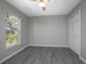 Bright bedroom with hardwood floors, ceiling fan, window, and closet at 2841 Idleweise Dr, Deltona, FL 32738