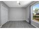 Comfortable bedroom with hardwood floors, ceiling fan, and large window at 2841 Idleweise Dr, Deltona, FL 32738