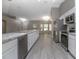 Modern kitchen featuring stainless steel appliances, granite countertops, and sleek gray flooring at 2841 Idleweise Dr, Deltona, FL 32738