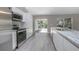 Contemporary kitchen with stainless steel appliances, granite countertops, and a backyard view at 2841 Idleweise Dr, Deltona, FL 32738