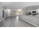 Bright and open living space with modern gray flooring, and a kitchen island at 2841 Idleweise Dr, Deltona, FL 32738