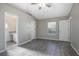 Spacious main bedroom with hardwood floors, ceiling fan, and ensuite bathroom at 2841 Idleweise Dr, Deltona, FL 32738