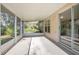 A view of the screened porch with a ceiling fan, concrete floor and sliding glass doors at 2841 Idleweise Dr, Deltona, FL 32738