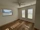 Bright bedroom with wood-look floors and two windows at 2929 Carriage Dr, South Daytona, FL 32119
