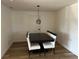 Dining room with modern light fixture, wood-look floors, and dining table at 2929 Carriage Dr, South Daytona, FL 32119