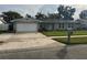 Charming single-story home features a well-manicured lawn, tidy landscaping, and an attached two-car garage at 2929 Carriage Dr, South Daytona, FL 32119
