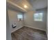 Small bedroom with wood-look flooring, natural lighting, and neutral colored walls at 305 Elsie Ave, Daytona Beach, FL 32117