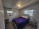 Bedroom with a bed, wood-look flooring, and natural light through large windows at 305 Elsie Ave, Daytona Beach, FL 32117