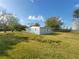 Exterior view of a cozy light blue home with white trim and a large, well-maintained yard at 305 Elsie Ave, Daytona Beach, FL 32117