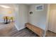 Hallway with wood-look flooring, natural colored furniture, and beach-themed wall decor at 305 Elsie Ave, Daytona Beach, FL 32117