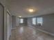 Bright living room with tile flooring, neutral paint, and access to the front door at 305 Elsie Ave, Daytona Beach, FL 32117