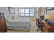 Bright bedroom featuring a large window, neutral walls, and a comfortable bed with a white comforter at 3051 S Atlantic Ave # 2206, Daytona Beach, FL 32118