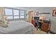 Bright bedroom with a large window and shutter, featuring a comfortable bed, and a workspace at 3051 S Atlantic Ave # 2206, Daytona Beach, FL 32118