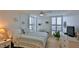 Bright bedroom with a ceiling fan, plantation shutters and beach-themed decor at 3051 S Atlantic Ave # 2206, Daytona Beach, FL 32118