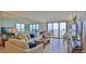 Bright living room with mirrored wall, comfortable seating and panoramic ocean views at 3051 S Atlantic Ave # 2206, Daytona Beach, FL 32118