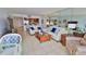 Relax in the living room with comfortable seating and a view into the kitchen area at 3051 S Atlantic Ave # 2206, Daytona Beach, FL 32118