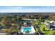 Aerial view of community: pool, clubhouse, tennis, and surrounding residences at 3102 Cordgrass Ct, The Villages, FL 32163