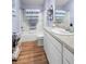 Cozy bathroom features a shower-tub combo with a striped curtain and modern fixtures at 3102 Cordgrass Ct, The Villages, FL 32163