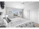 Bedroom featuring a comfortable bed, neutral colors, and views of the neighborhood at 3102 Cordgrass Ct, The Villages, FL 32163