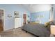 Stylish bedroom with blue walls, gray bed linens, and a cozy work space at 3102 Cordgrass Ct, The Villages, FL 32163