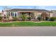 Charming single-story home with manicured landscaping, including shrubs and decorative grass at 3102 Cordgrass Ct, The Villages, FL 32163