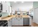 Bright kitchen with modern stainless steel appliances and an open layout to the living room at 3102 Cordgrass Ct, The Villages, FL 32163