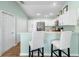 Charming kitchen featuring white cabinets, a breakfast bar, and stainless steel appliances at 3102 Cordgrass Ct, The Villages, FL 32163