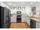 Well-lit kitchen featuring stainless steel appliances, white cabinetry, and ample counter space at 3102 Cordgrass Ct, The Villages, FL 32163