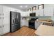 Contemporary kitchen with stainless steel appliances, white cabinets, and ample counter space at 3102 Cordgrass Ct, The Villages, FL 32163