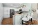 Well-lit kitchen with modern stainless steel appliances, white cabinetry, and breakfast bar seating at 3102 Cordgrass Ct, The Villages, FL 32163