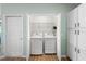 Convenient laundry closet with a full size washer and dryer, next to additional storage at 3102 Cordgrass Ct, The Villages, FL 32163