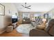 Comfortable living room with a ceiling fan, natural light, and cozy furnishings for relaxation at 3102 Cordgrass Ct, The Villages, FL 32163